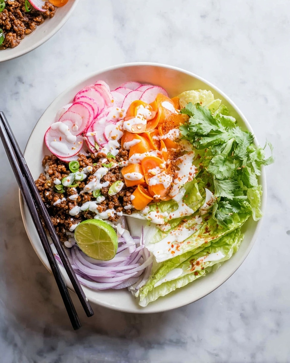 The dish is served in a white bowl placed on a white marbled surface. It has five main layers arranged in sections: on the left, there are thin slices of pink radish with green stems, next to a portion of brown cooked minced meat topped with a drizzle of white sauce; above this is a cluster of small, bright orange carrot slices also drizzled with white sauce and sprinkled with red seasoning. On the right side, there are two wedges of pale green lettuce with white sauce and red seasoning over them. Fresh green cilantro leaves fill the space between the lettuce and carrot. A wedge of lime with a bright green rind and pale green inside rests near the lettuce. Two black chopsticks lie diagonally on the bottom left of the bowl, resting partly on a pile of thin slices of pale purple onion. Photo taken with an iphone --ar 4:5 --v 7