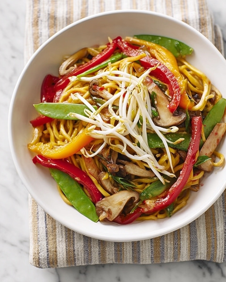 A white bowl filled with a colorful stir-fried noodle dish sits on a striped cloth over a white marbled surface. The dish has a base layer of thick yellow noodles mixed with thin slices of light brown mushrooms and small green snap peas. On top, there are bright red and yellow bell pepper strips and fresh white bean sprouts adding a crunchy texture. The vegetables appear lightly cooked, showing vibrant colors with a slight shine. photo taken with an iphone --ar 4:5 --v 7
