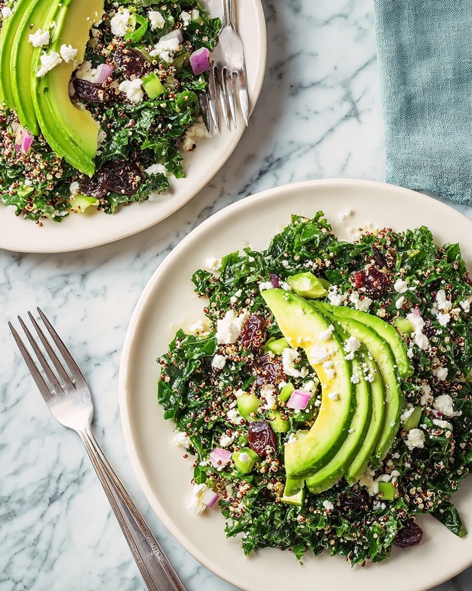 The image shows two white plates on a white marbled surface, each holding a fresh salad made mainly of chopped kale mixed with small pieces of quinoa, celery, and red onion, with dark raisins scattered throughout. On top of the salad, there is a nicely fanned layer of sliced bright green avocado placed near the center of each plate, with crumbled white cheese sprinkled over the avocado and some salad. One plate has a silver fork resting on the edge, while the other has a woman's hand holding a fork diving into the salad. Photo taken with an iphone --ar 4:5 --v 7