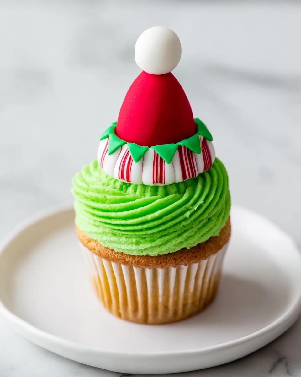 A cupcake with a golden brown base wrapped in a light paper liner sits on a white plate with a white marbled background. On top, thick, bright green frosting is piped in tight swirls forming one layer. Above the frosting is a small decoration resembling a red Santa hat, complete with a white pom-pom and green brim, sitting on a white and red-striped ruffle that looks soft and puffy. The overall look is festive and colorful, perfect for Christmas. photo taken with an iphone --ar 4:5 --v 7