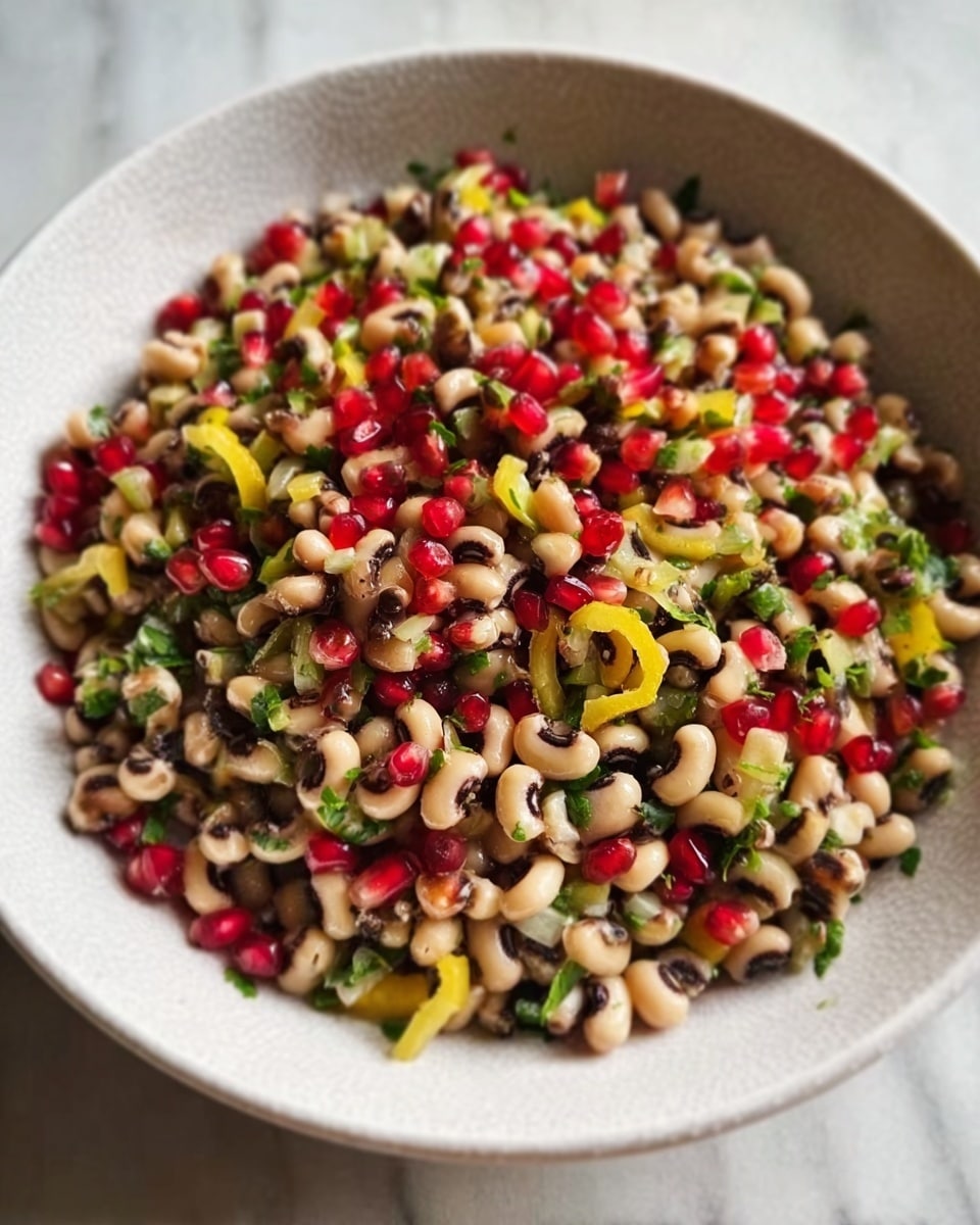 A white bowl filled with a colorful salad consisting of three visible layers: the bottom layer is a mix of black-eyed peas and small chopped green and yellow vegetables, the middle layer includes bright green pieces of chopped celery or cucumber, and the top layer is covered with shiny red pomegranate seeds, adding a pop of color. The salad looks fresh and vibrant, sitting on a white marbled surface. photo taken with an iphone --ar 4:5 --v 7