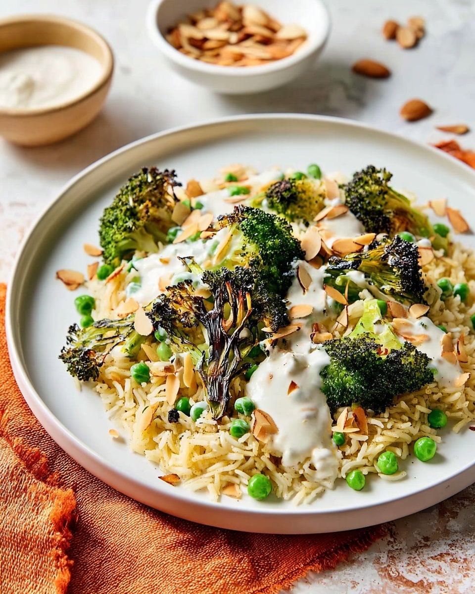 A white plate on a white marbled surface holds a dish with a base layer of cooked white rice mixed with small green peas. On top, there are several pieces of grilled broccoli with charred edges, adding a dark green and black contrast. Scattered over the broccoli and rice are thin, toasted almond slices that are light brown. The dish is drizzled with a white creamy sauce, creating a fresh texture throughout. Around the plate are two small white bowls, one containing extra toasted almond slices and the other with more white sauce. A bright orange cloth lies next to the plate, adding a warm color to the scene. photo taken with an iphone --ar 4:5 --v 7