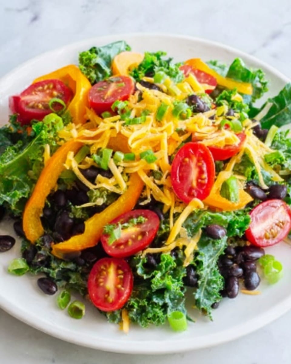 A white plate with a colorful salad on a white marbled surface. The salad has a base layer of dark green kale leaves, topped with black beans scattered evenly. There are slices of bright red cherry tomatoes and thin strips of yellow bell pepper spread over the black beans. On top, there are small pieces of chopped green onions and some shredded cheese adding light yellow accents. The overall look is fresh and vibrant, with a mix of chunky and leafy textures. photo taken with an iphone --ar 4:5 --v 7